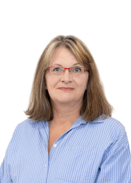 A woman with shoulder-length brown hair and red glasses wearing a blue and white striped shirt, facing forwards against a plain white background.